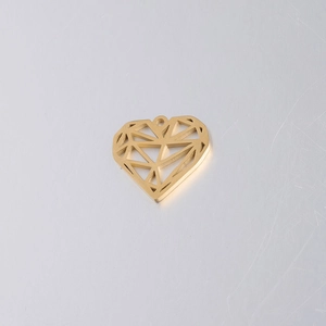 Macro detail of golden stainless steel heart pendant with geometric faceted design