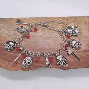 Détail du bracelet à breloques de films d'horreur avec Jason et Freddy sur bois