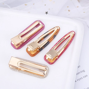 Set of four acetic acid hair clips in pink, crimson, silver, and tortoiseshell patterns