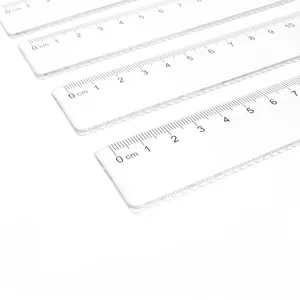 Transparent plastic rulers with wave edges and black centimeter markings on white background