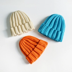 Classic knitted beanies in beige, blue, and orange colors for winter warmth