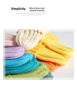Close-up of classic ribbed knit texture and assorted vibrant colors of winter beanies