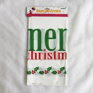 Nappe de Noël jetable emballée avec motifs de houx et texte festif rouge et vert