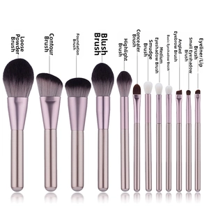 Close-up of 12 makeup brushes with soft gradient bristles and golden handles
