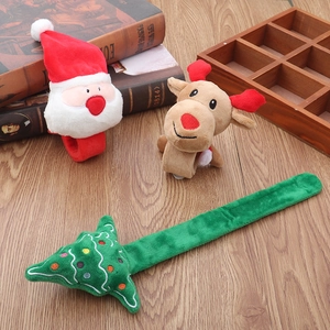 Close-up of Christmas plush slap bracelets featuring Santa, reindeer, and tree designs