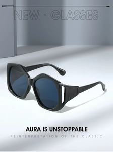 Macro shot of oversized sunglasses with hollowed-out temple joints and dark blue lenses