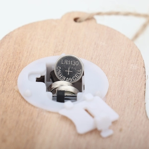 Lighted wooden Christmas pendant detail featuring LR1130 battery compartment back view