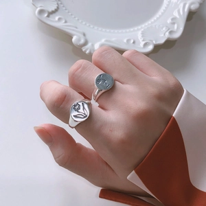 925 sterling silver rings with tulip and abstract face engravings on circular metal discs