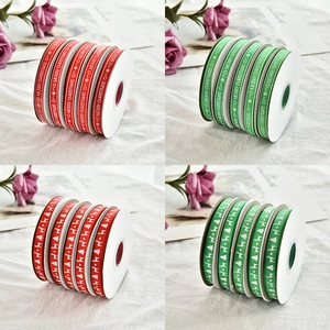 Detail of red and green Christmas ribbons with Merry Christmas prints and reindeer patterns