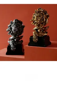 Detailed view of resin lion head sculptures in gold and silver finish with mane textures