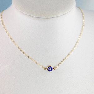 Bohemian gold chain necklace with a vintage blue evil eye pendant on a neck mannequin