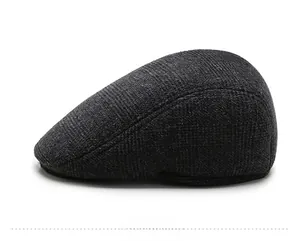 Side view of dark grey winter flat cap for elderly men with ear protection and textured fabric