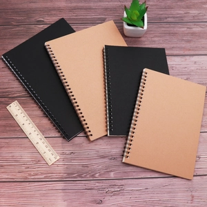 Minimalist spiral kraft notebooks in black and brown colors on vintage wood background