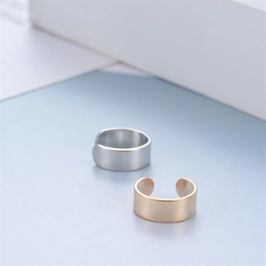 Minimalist U-shape cuff earring in gold and silver finish on elegant blue surface