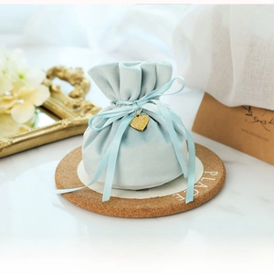 Detail of light blue velvet wedding favor bag with handmade love heart charm