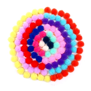Flat lay of colorful plush pom pom balls in spiral arrangement for pet hair accessories