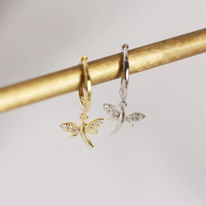 Detail of S925 sterling silver dragonfly hoop earrings with clear cubic zirconia stones