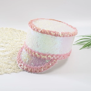 Close-up of sparkling white sequins and pink lace trim on a stylish military cap
