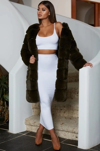 Detail of premium olive green faux fur coat texture and long plush sleeve design