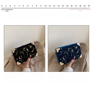 Detail of velvet box bags with gold embroidery, metal corners and chain straps