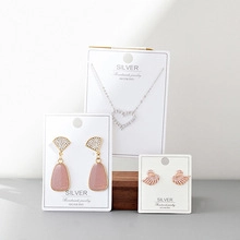 Detail view of S925 silver jewelry set with heart necklace and pink swan earrings