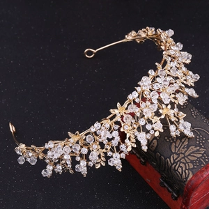 Detail of a handmade bridal crown with crystal flowers and vintage wooden jewelry box