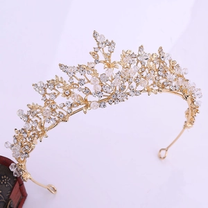 Close-up of golden bridal crown with intricate handmade crystal floral patterns