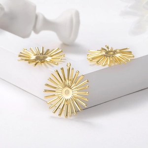 Golden sunburst charms for DIY jewelry making shown on a clean white background