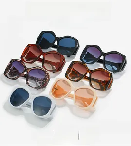 Flat lay of geometric oversized sunglasses in black, leopard, and beige patterns