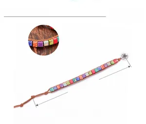 Macro detail of natural colorful emperor stone beads and floral buckle on leather bracelet