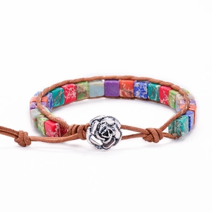 Close-up of handmade bohemian bracelet with colorful stones and silver rose clasp