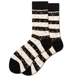 Detailed macro view of colorful speckled black and white striped cotton mid-tube socks