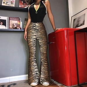 Detail of high waisted leopard print flare pants with a black halter neck bodysuit top