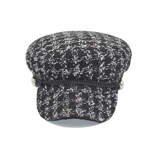 Classic black and white tweed newsboy cap with silver buttons and braided rope detail