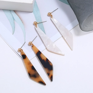 Macro view of geometric acetate resin earrings in tortoise shell and marble patterns