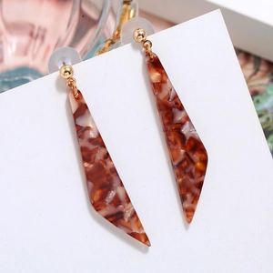 Detailed shot of long geometric acetate earrings with tortoise shell pattern and gold studs