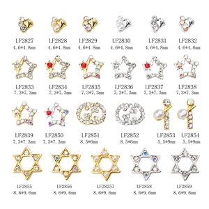 Assorted butterfly and star nail charms with rhinestones and pearls in gold and silver