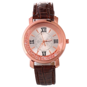 Close-up of rose gold watch face with roman numerals and brown crocodile leather strap