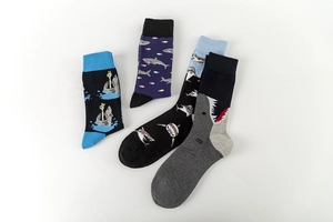 Detailed view of colorful shark pattern crew socks in navy, black, and grey cotton
