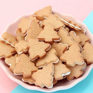 Close-up of resin mini Christmas tree biscuits on a pink tray for DIY crafts