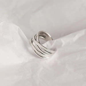 Macro shot of S925 sterling silver multilayer woven ring with hallmark on white background