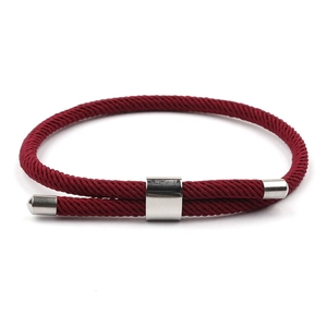 Detail of red Milanese cord bracelet featuring adjustable metal slider and textured weave