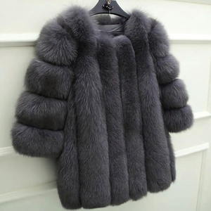 Detailed texture of grey faux fur coat showing long plush fibers on a hanger