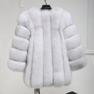 Close-up of white faux fur coat with horizontal panel design and soft plush texture