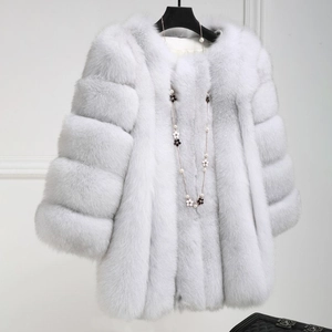 Close-up of light grey faux fur coat texture with elegant flower necklace detail