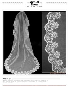 Detail of 3m long white bridal veil with intricate floral lace embroidery borders