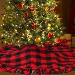 Detail of red and black buffalo plaid Christmas tree skirt with ruffled edges texture