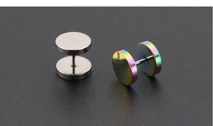 Detail of silver and rainbow titanium barbell stud earrings on a dark matte surface