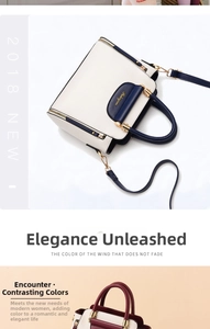 Detail of color-block PU leather handbag with gold hardware and detachable strap