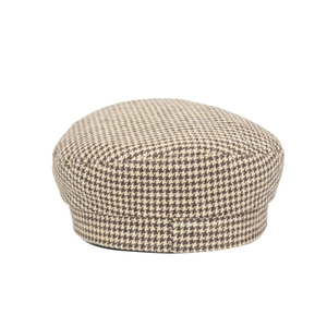 Detailed view of brown and beige houndstooth pattern fabric on a classic beret hat